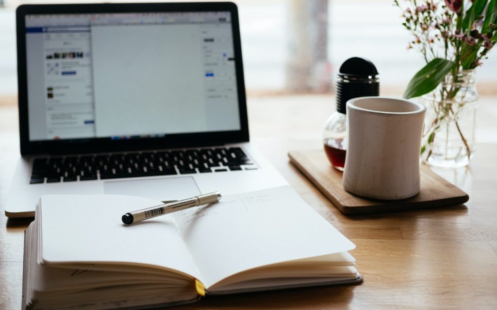 MacBook Pro near white open book